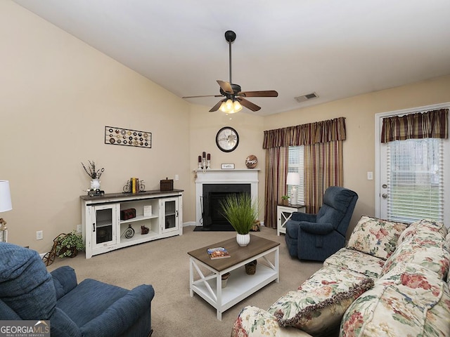 living room with ceiling fan and carpet