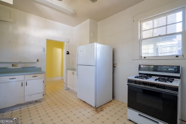 kitchen with white cabinets and white appliances