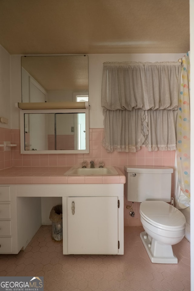 bathroom with tasteful backsplash, vanity, and toilet