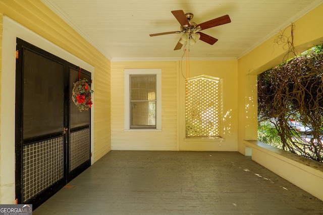 unfurnished sunroom with ceiling fan