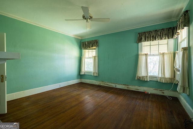 spare room with ornamental molding, plenty of natural light, dark wood-type flooring, and ceiling fan