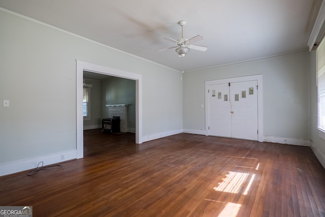 empty room featuring dark hardwood / wood-style floors, ceiling fan, and crown molding