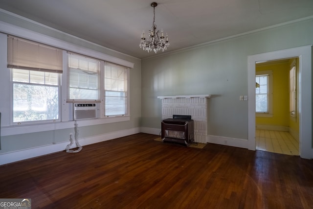 unfurnished living room featuring cooling unit, crown molding, a chandelier, dark hardwood / wood-style floors, and a wood stove