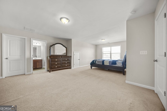 bedroom with light colored carpet, visible vents, connected bathroom, a sink, and baseboards