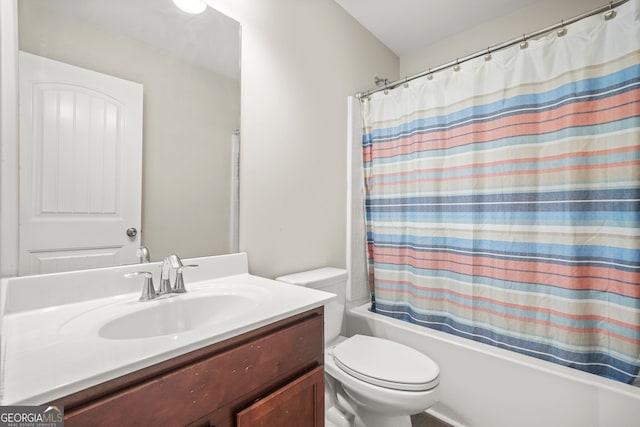 bathroom featuring toilet, shower / bath combination with curtain, and vanity