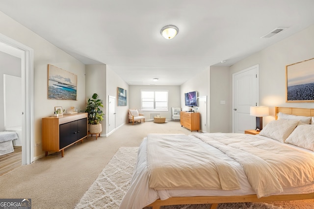 bedroom with carpet, visible vents, and baseboards