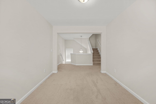 interior space with carpet flooring, stairway, and baseboards