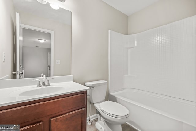 full bathroom featuring tub / shower combination, vanity, and toilet