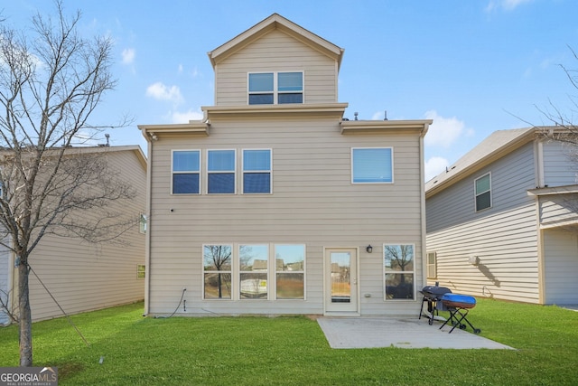 rear view of property with a yard and a patio