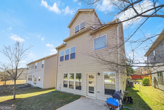 back of property with a yard, central AC, and a patio area