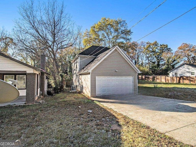 view of side of property featuring central AC, a yard, and solar panels