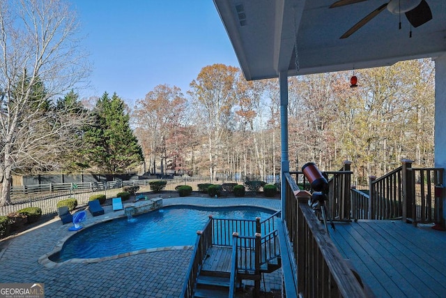 view of pool featuring ceiling fan and a deck