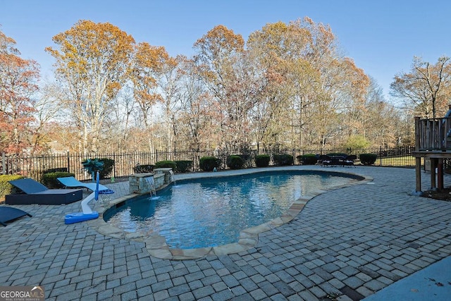 view of swimming pool featuring pool water feature and a patio