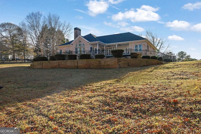 back of house with a lawn