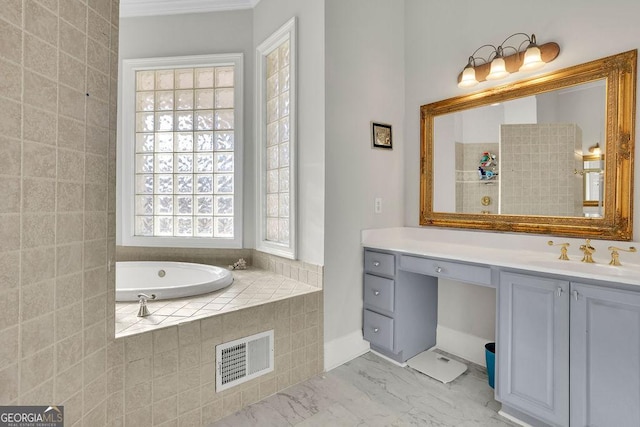 bathroom featuring vanity and tiled bath