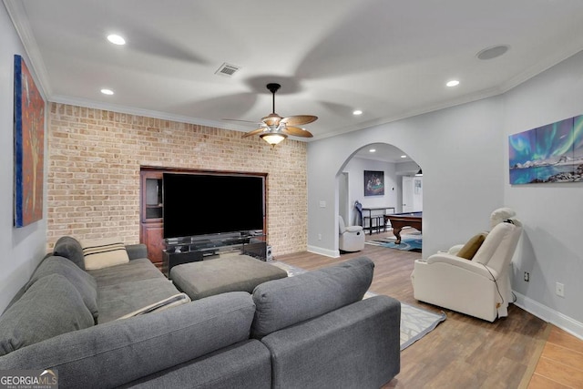 living room with brick wall, ornamental molding, and pool table