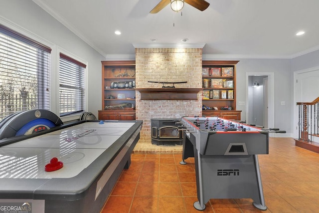 rec room featuring tile patterned flooring, ceiling fan, and crown molding