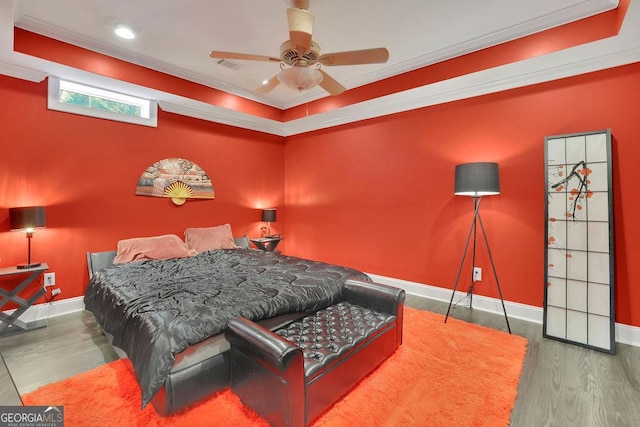 bedroom featuring ceiling fan, hardwood / wood-style floors, and ornamental molding