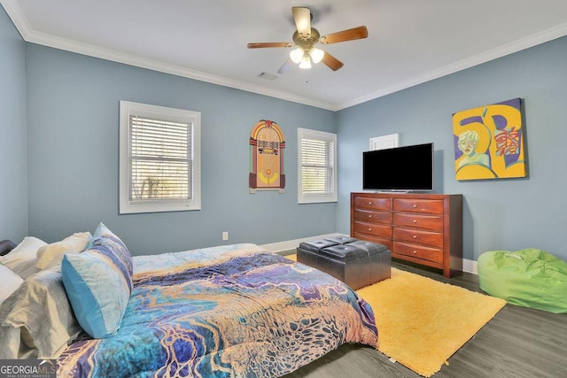 bedroom with multiple windows, ceiling fan, ornamental molding, and hardwood / wood-style flooring