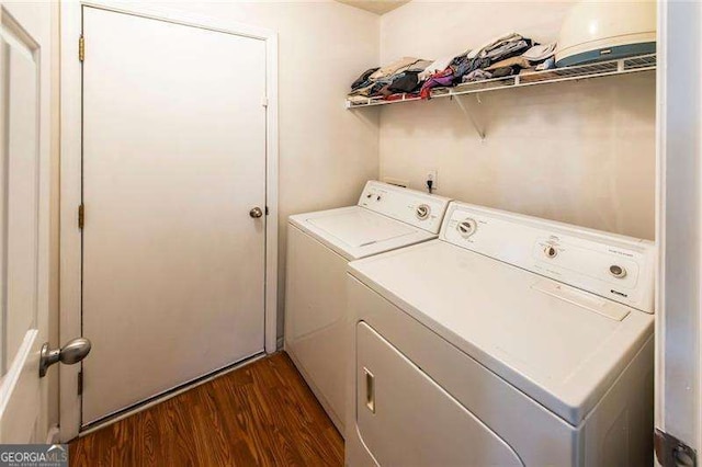 laundry room featuring dark hardwood / wood-style flooring and separate washer and dryer