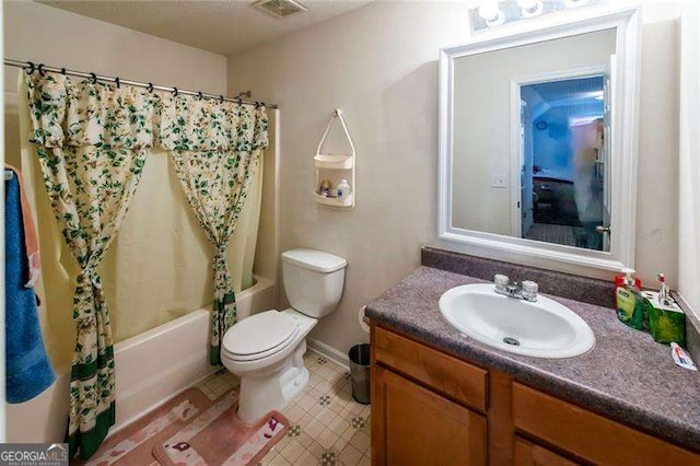 full bathroom featuring vanity, shower / tub combo, and toilet