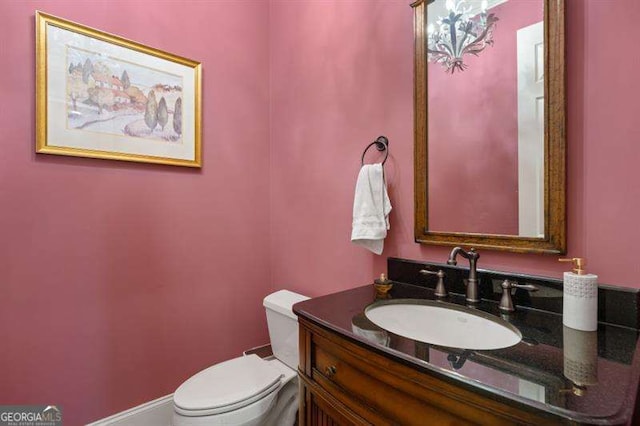 bathroom featuring vanity and toilet