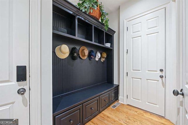 mudroom with light hardwood / wood-style floors