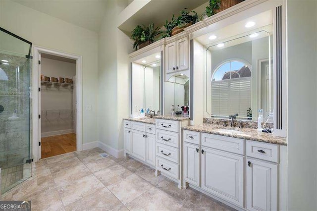 bathroom featuring vanity and a shower with shower door