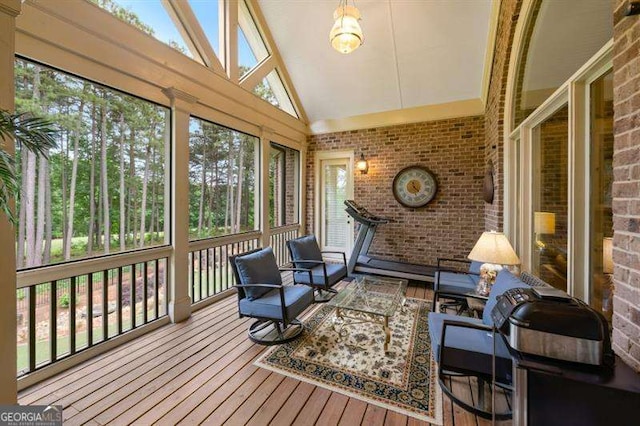 sunroom featuring lofted ceiling