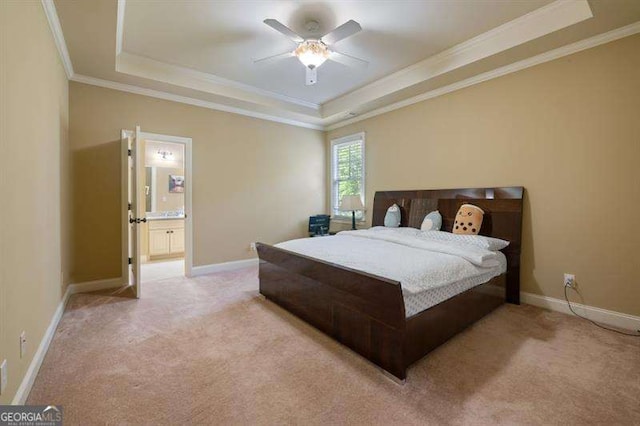 carpeted bedroom featuring a tray ceiling, ceiling fan, and ornamental molding