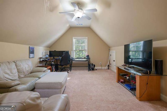 carpeted home office with ceiling fan and vaulted ceiling