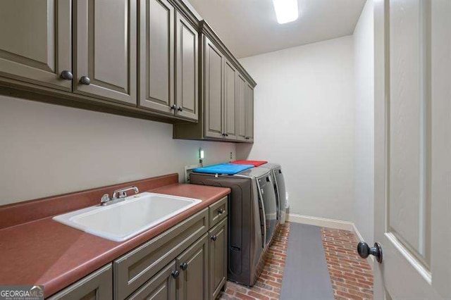 washroom featuring cabinets, independent washer and dryer, and sink