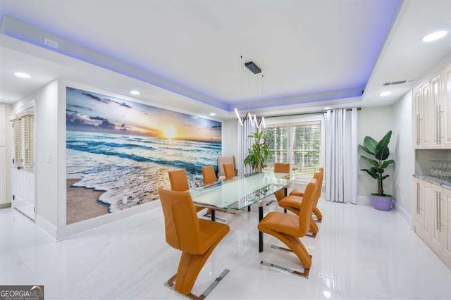 dining space featuring a raised ceiling