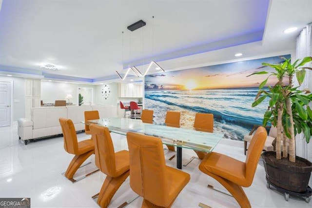 dining area featuring a raised ceiling