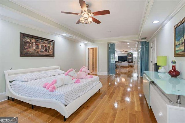 bedroom with light hardwood / wood-style flooring, ceiling fan, and crown molding