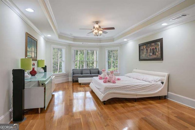 bedroom with light wood-type flooring, ceiling fan, and crown molding