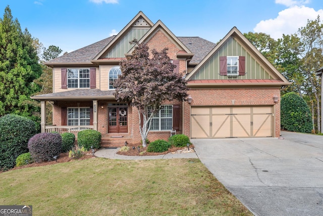 craftsman-style home with covered porch, a garage, and a front lawn