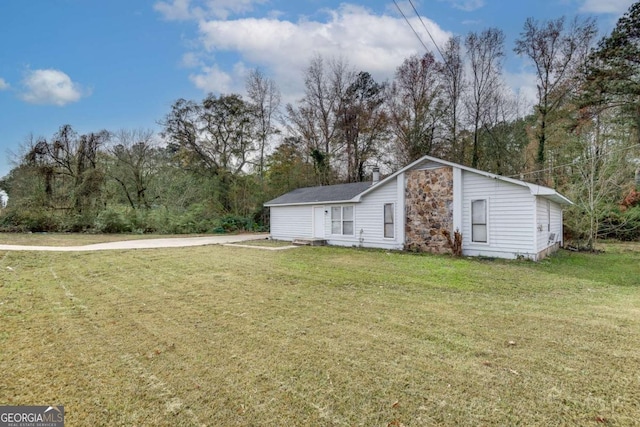 view of side of home featuring a lawn