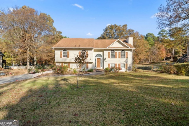 raised ranch with a front yard