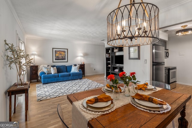 dining area with light wood-type flooring and crown molding