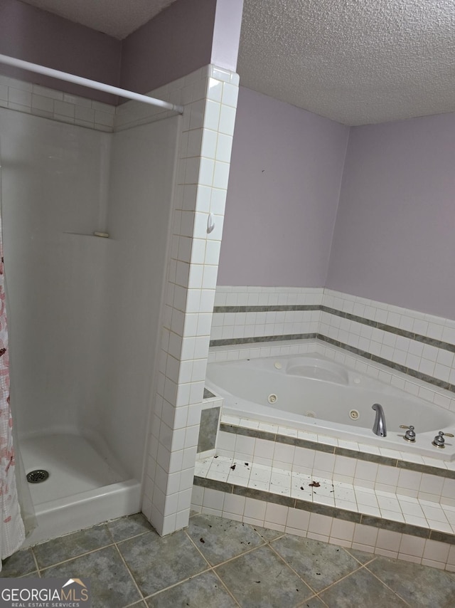 bathroom with tile patterned flooring, a textured ceiling, and independent shower and bath