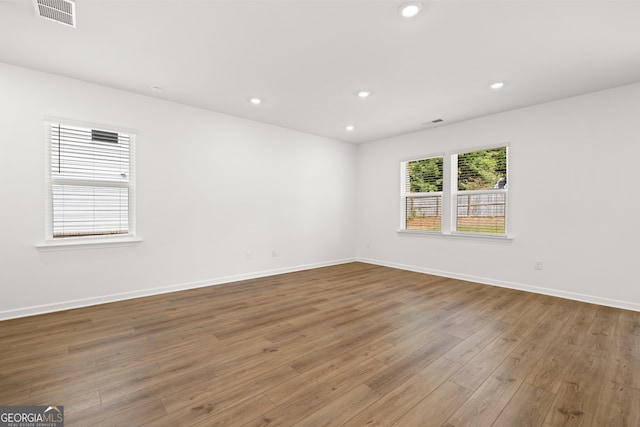 unfurnished room featuring hardwood / wood-style flooring