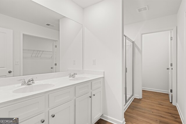 bathroom with vanity, hardwood / wood-style flooring, and an enclosed shower