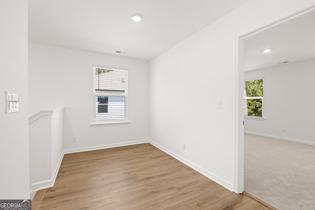 empty room with light hardwood / wood-style flooring