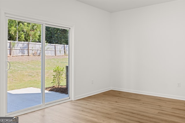 spare room with light hardwood / wood-style flooring