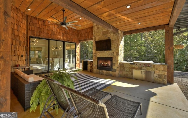 view of patio / terrace with an outdoor stone fireplace, area for grilling, and ceiling fan