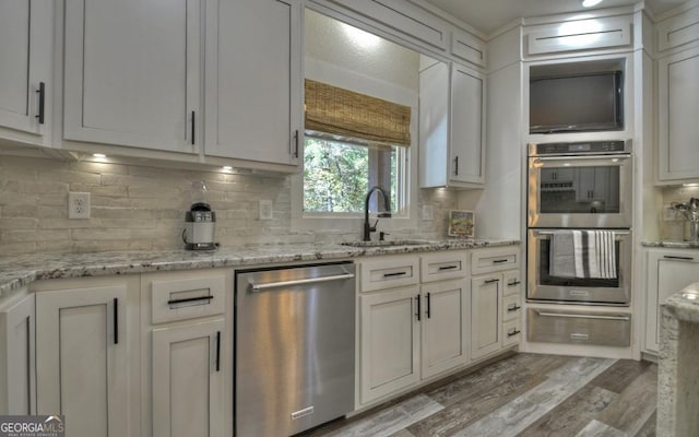 kitchen with white cabinets, stainless steel appliances, and sink