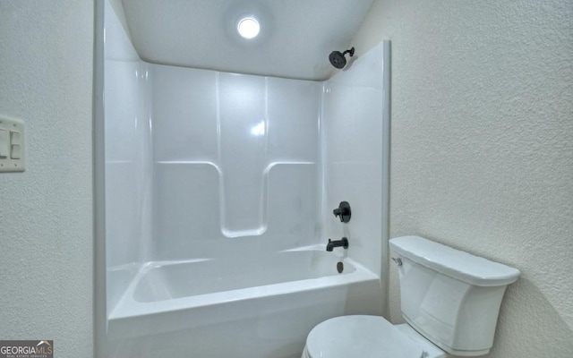 bathroom with toilet and bathtub / shower combination