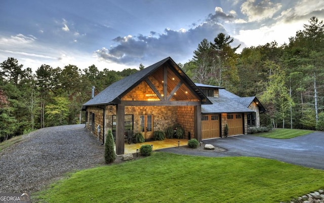 view of front of home with a garage and a front lawn