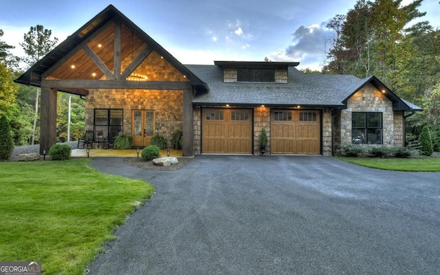 view of front of house with covered porch, a garage, and a front yard